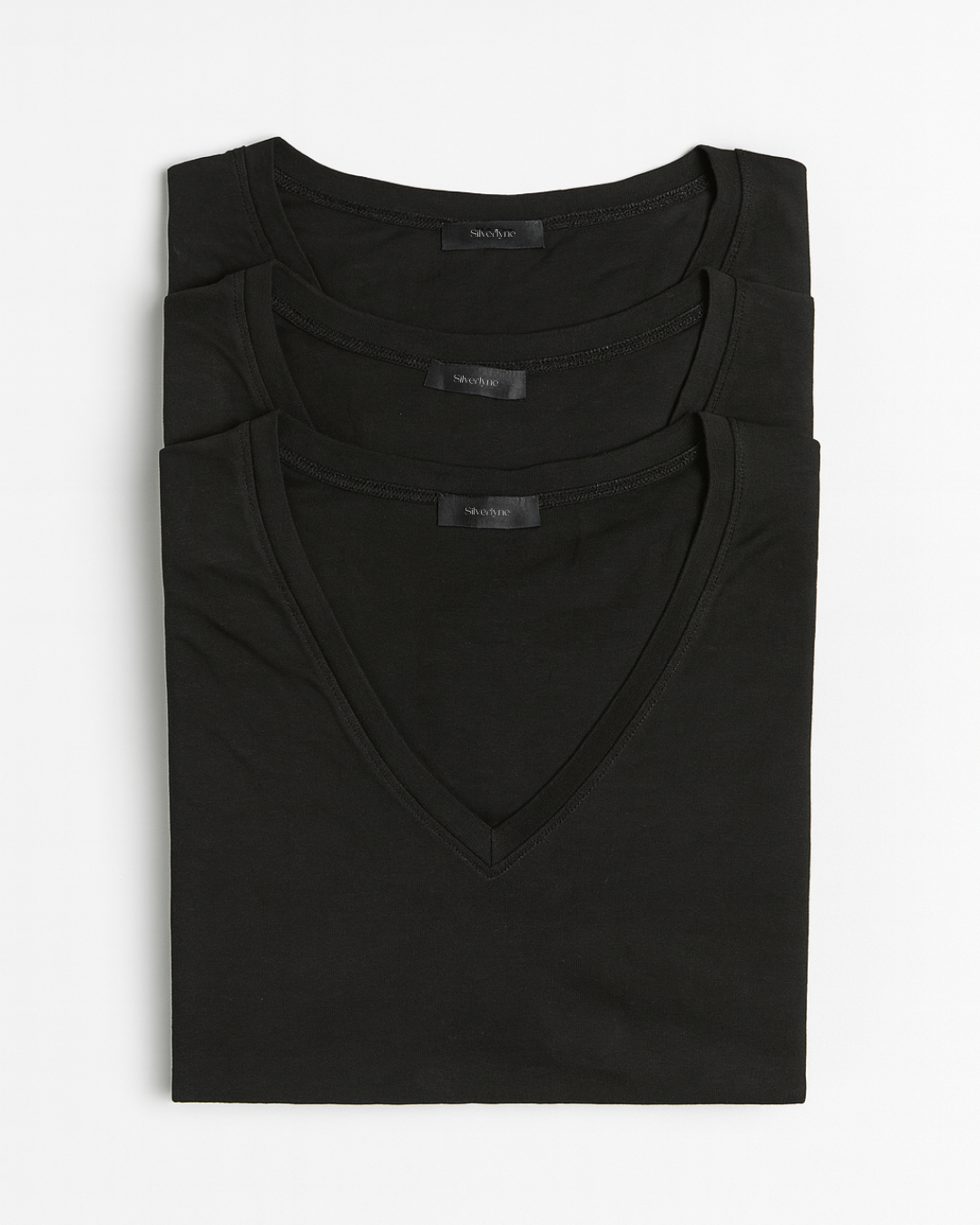 Three folded black Timeless Tencel Short-sleeve V-neck T-shirt  on a white background